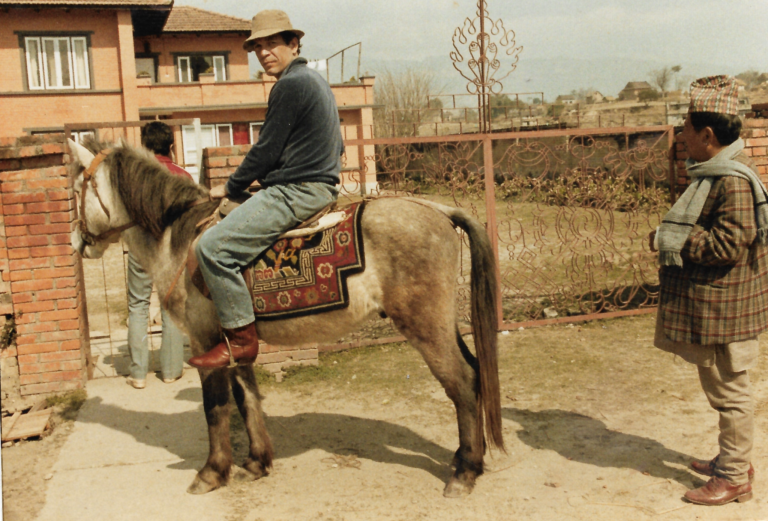 Joe Pietri, the legendary 1960s drug smuggler and cannabis seed collector, riding a horse in a rustic setting, symbolizing his landrace seed expeditions.